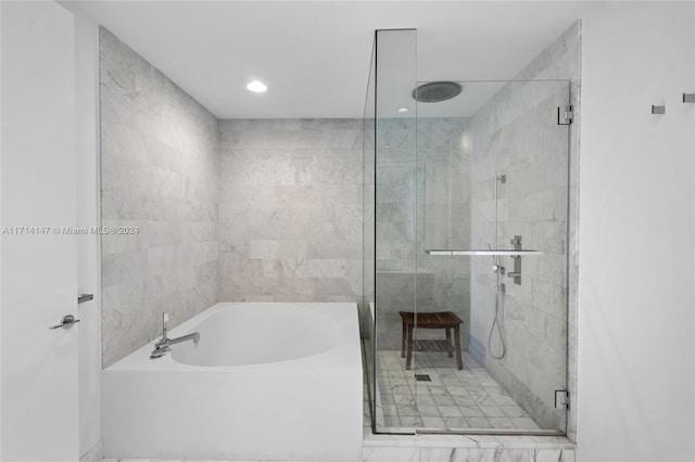 bathroom featuring shower with separate bathtub