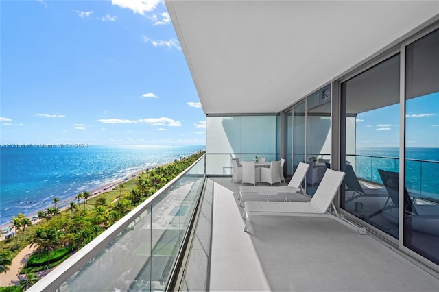 balcony with a water view and a beach view