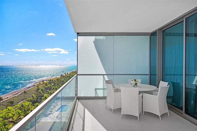 balcony with a water view and a beach view