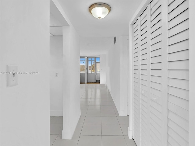 hall featuring light tile patterned flooring