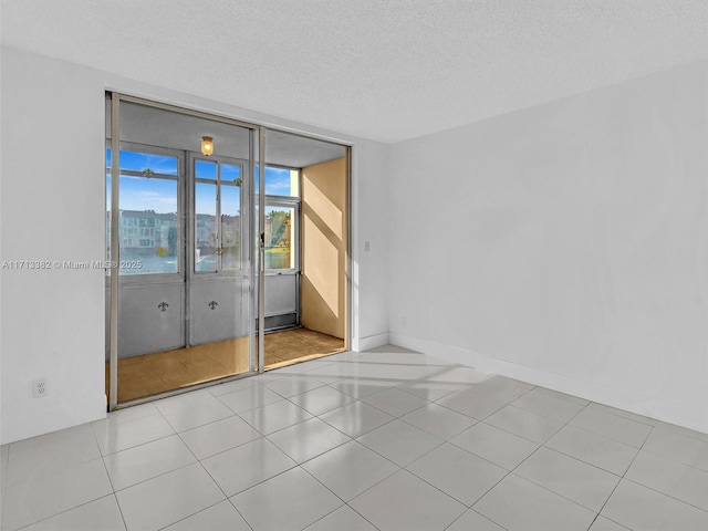 unfurnished room with a textured ceiling and a water view