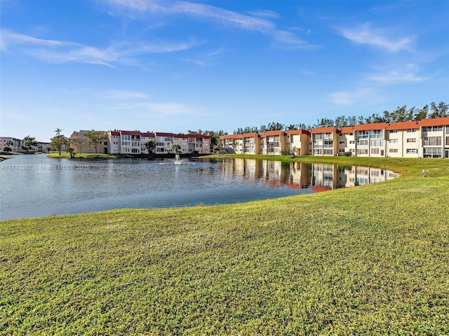 dock area with a water view and a lawn