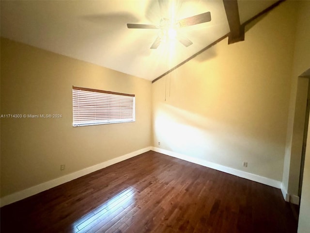 empty room featuring lofted ceiling with beams, ceiling fan, and dark wood-type flooring