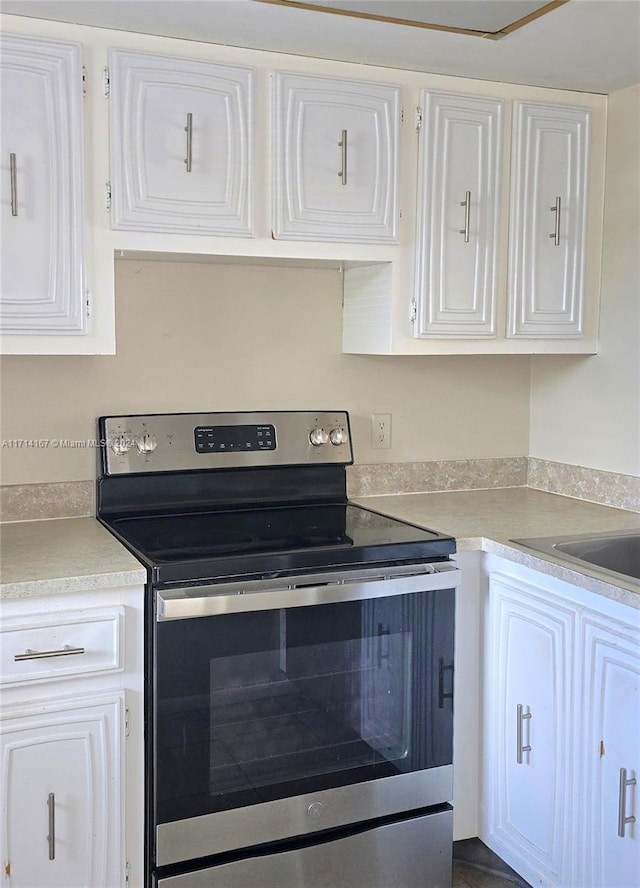 kitchen with white cabinets and stainless steel electric range