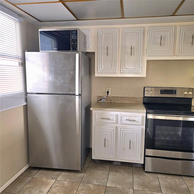 kitchen featuring white cabinetry, light tile patterned flooring, and appliances with stainless steel finishes