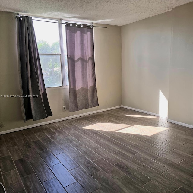 unfurnished room featuring a textured ceiling