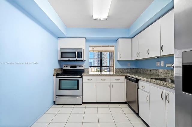 kitchen with white cabinetry, light tile patterned floors, and appliances with stainless steel finishes