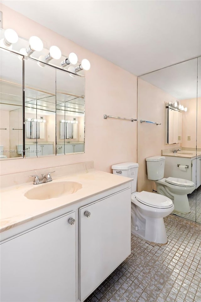 bathroom with tile patterned floors, vanity, and toilet