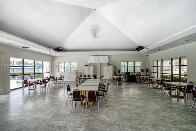 dining space with a chandelier and high vaulted ceiling