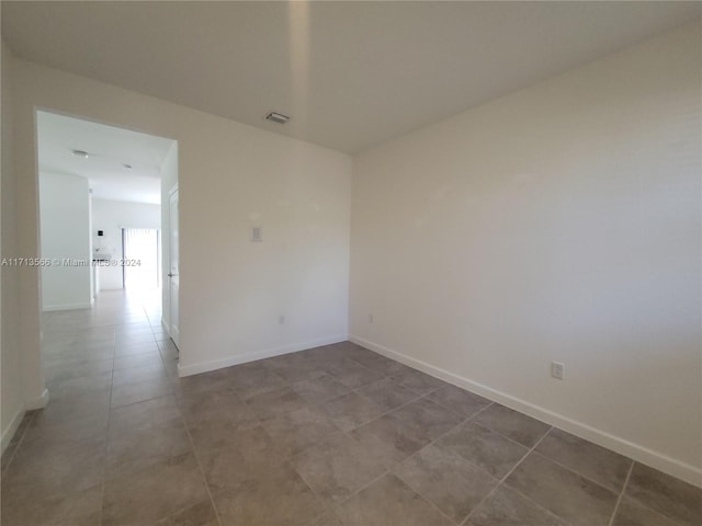 empty room with tile patterned floors