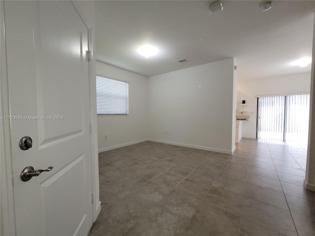 unfurnished room with tile patterned floors