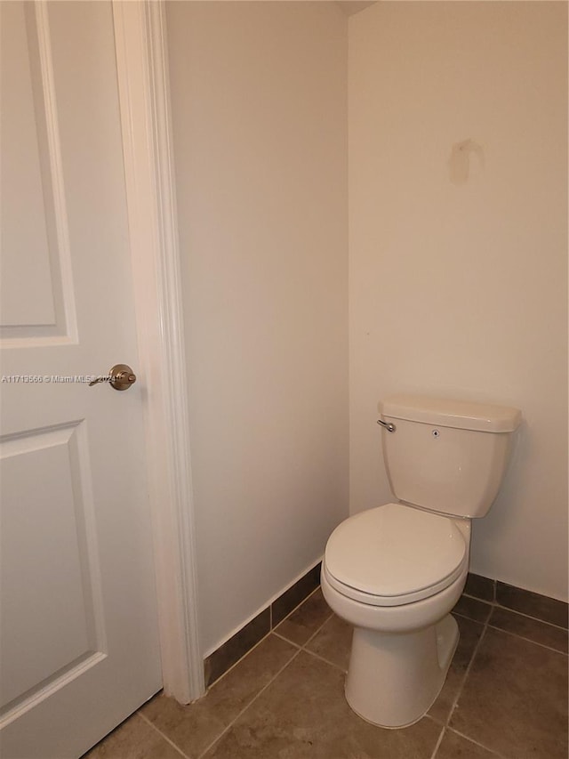 bathroom featuring tile patterned flooring and toilet