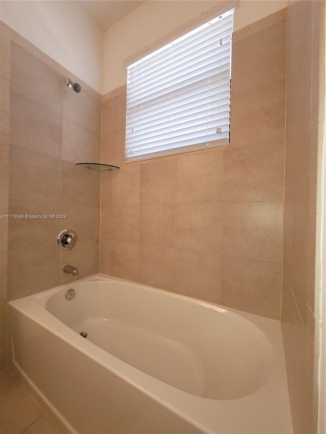 bathroom with tile patterned floors and tiled shower / bath combo