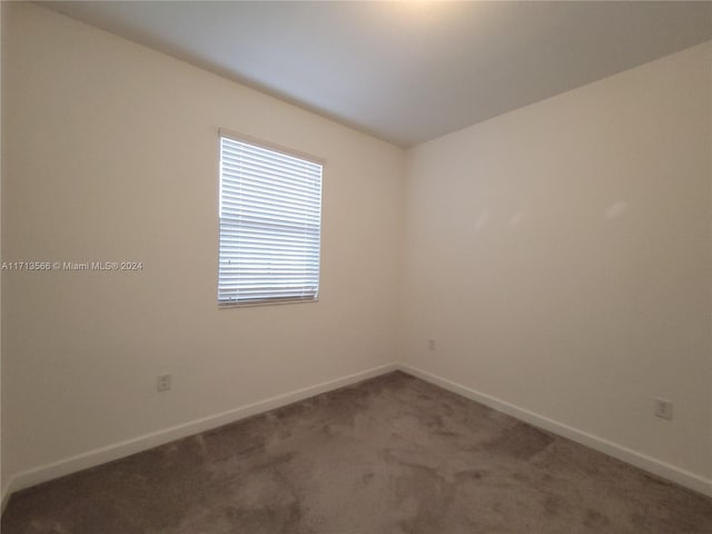 unfurnished room featuring carpet