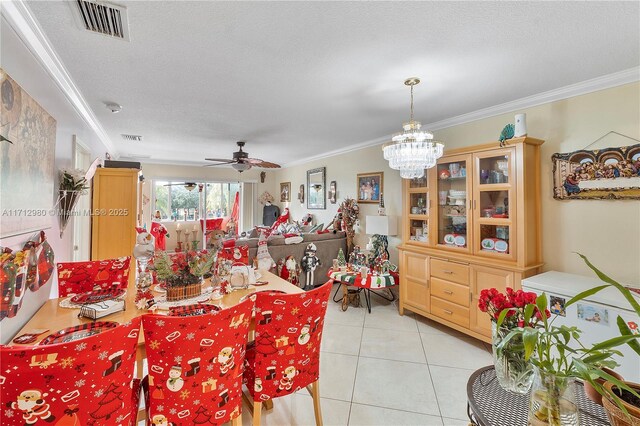 126 Sparrow Dr Unit 22B, Royal Palm Beach, FL 33411 - dining space featuring crown molding, ceiling fan, light tile patterned floors, and a chandelier
