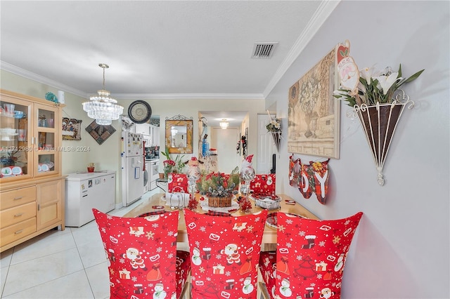 dining space featuring light tile patterned floors, crown molding, and an inviting chandelier