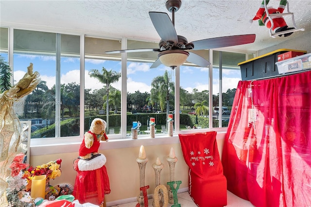 sunroom / solarium featuring a wealth of natural light and ceiling fan