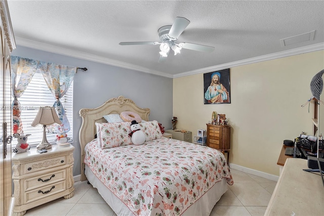 tiled bedroom with ceiling fan, a textured ceiling, and ornamental molding