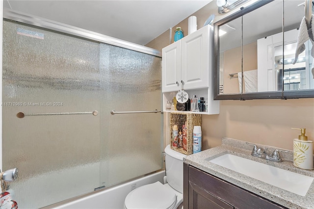 full bathroom with vanity, toilet, and bath / shower combo with glass door