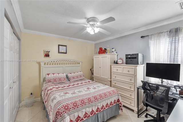 tiled bedroom with a textured ceiling, a closet, crown molding, and ceiling fan