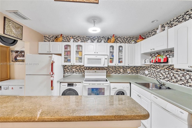 126 Sparrow Dr Unit 22B, Royal Palm Beach, FL 33411 - kitchen featuring white appliances, washer / clothes dryer, white cabinetry, glass insert cabinets, and a textured ceiling