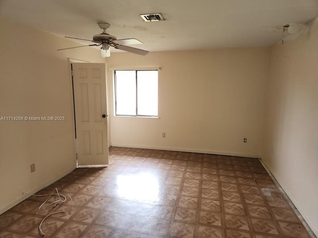 empty room featuring ceiling fan and light parquet floors