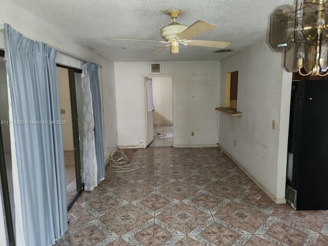 tiled spare room featuring ceiling fan and a textured ceiling