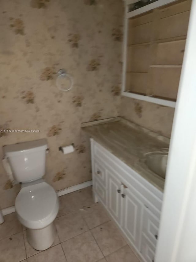 bathroom featuring tile patterned flooring, vanity, and toilet