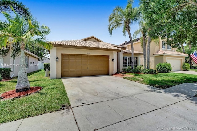 view of front of house with a garage and a front lawn