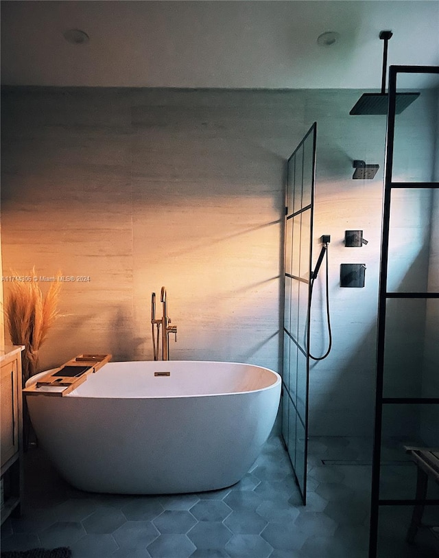 bathroom featuring tile patterned floors and a tub