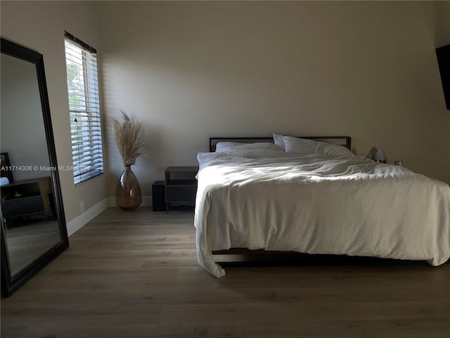 bedroom with hardwood / wood-style floors