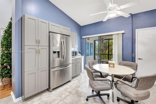 kitchen featuring ceiling fan, gray cabinets, appliances with stainless steel finishes, and vaulted ceiling