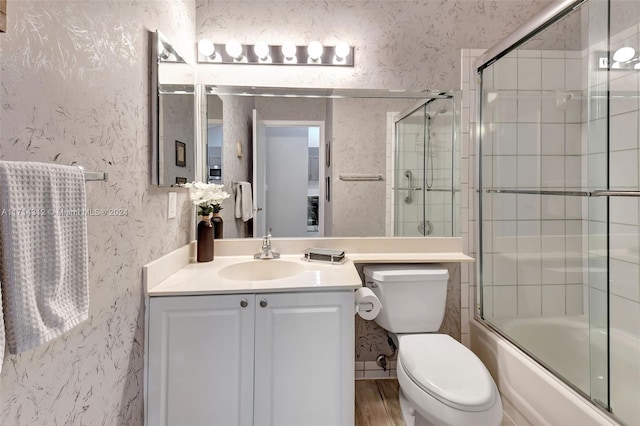 full bathroom featuring vanity, toilet, and enclosed tub / shower combo