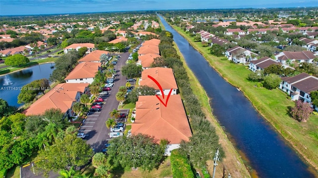 birds eye view of property with a water view