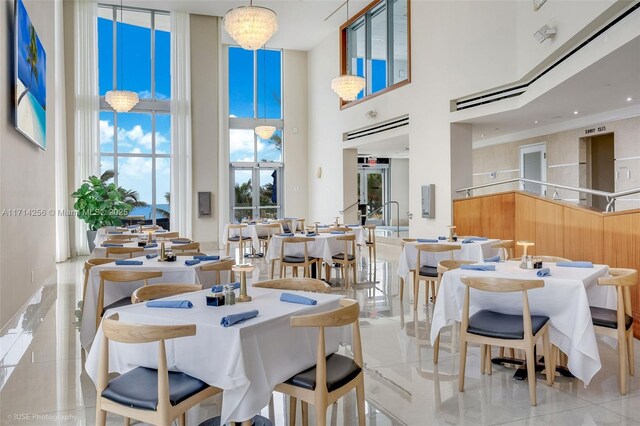 18683 Collins Ave Unit 1110, Sunny Isles Beach, FL 33160 - dining area with an inviting chandelier and a towering ceiling