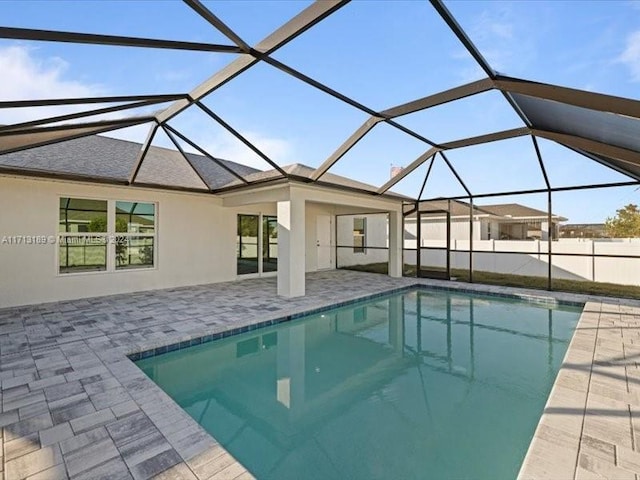 view of swimming pool featuring a lanai and a patio area