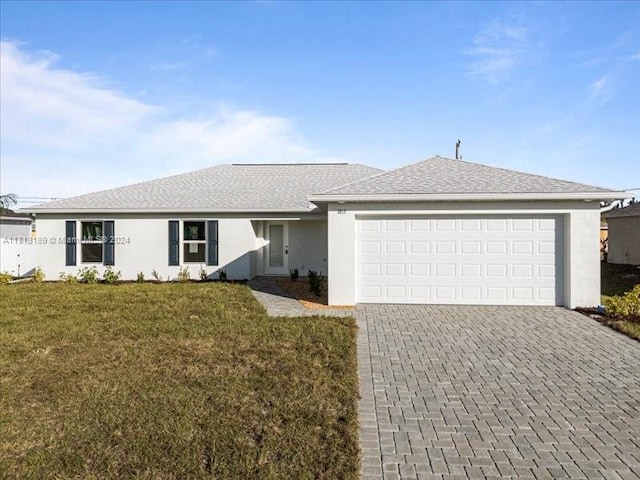 single story home featuring a front yard and a garage