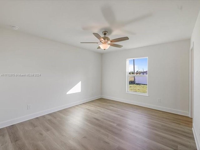 unfurnished room featuring ceiling fan and light wood-type flooring