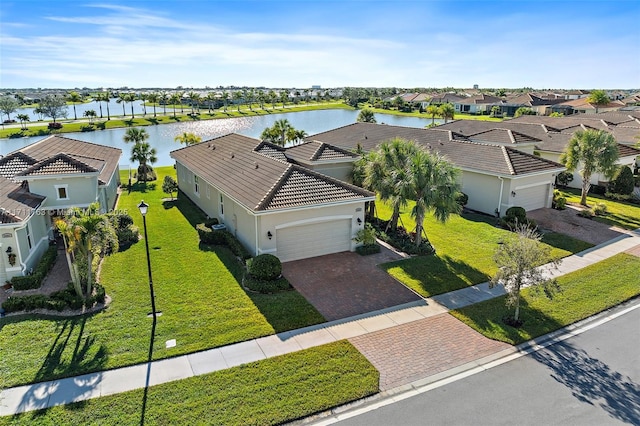 birds eye view of property with a residential view and a water view