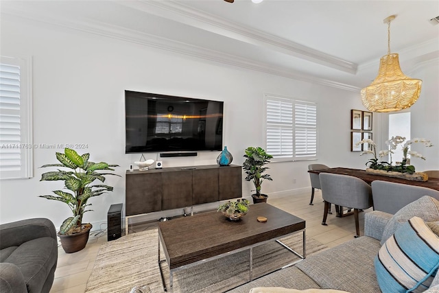 tiled living room featuring a tray ceiling and ornamental molding