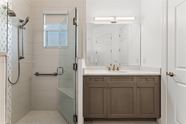 bathroom with vanity and a shower with shower door