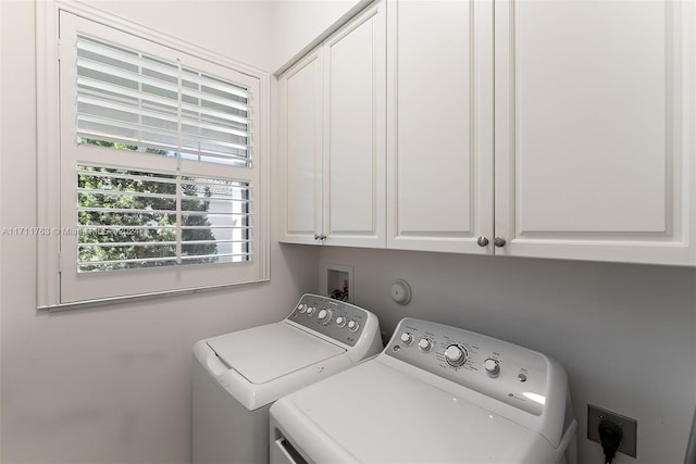 laundry room with cabinets and separate washer and dryer