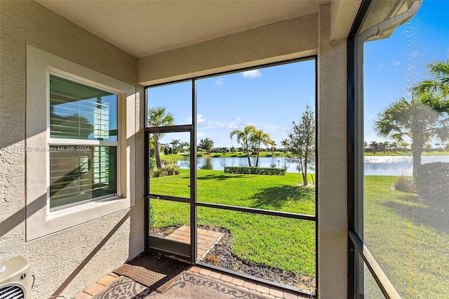 unfurnished sunroom with a water view