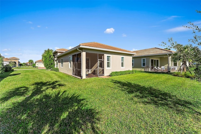 rear view of house with a lawn