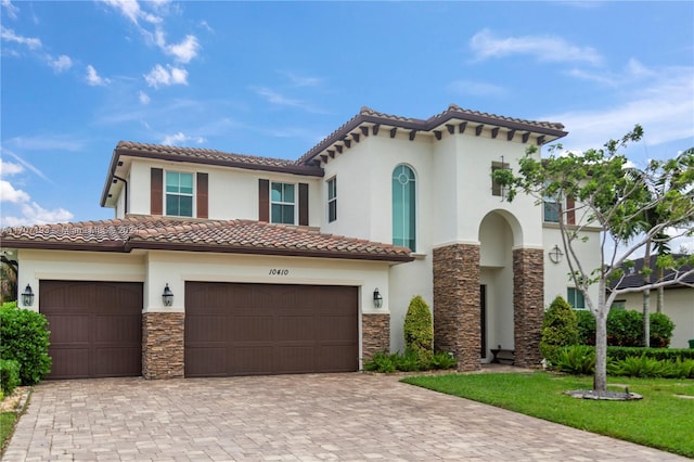 mediterranean / spanish house with a garage