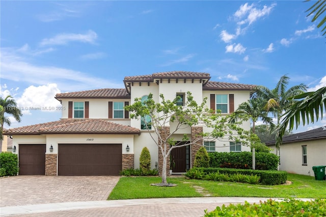 10410 Ranchette Dr, Cooper City, FL 33328 - mediterranean / spanish-style house featuring a tiled roof, decorative driveway, stucco siding, and a garage