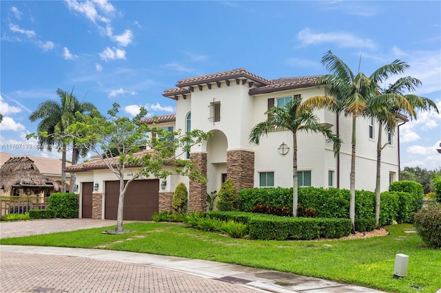 10410 Ranchette Dr, Cooper City, FL 33328 - mediterranean / spanish-style house with stone siding, decorative driveway, stucco siding, and a tiled roof