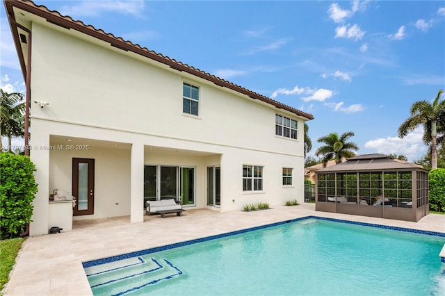 10410 Ranchette Dr, Cooper City, FL 33328 - back of property featuring stucco siding, a patio area, an outdoor pool, and a gazebo