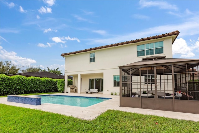 10410 Ranchette Dr, Cooper City, FL 33328 - back of property with a sunroom, stucco siding, a patio area, and a lawn