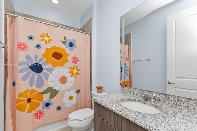 bathroom featuring a shower with curtain, vanity, and toilet